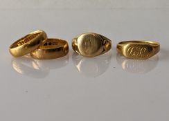 Two 22ct yellow gold wedding bands, both 5mm and two 18ct yellow gold signet rings