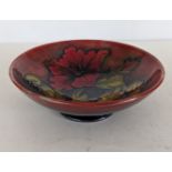 A William Moorcroft hibiscus pattern bowl on a raised foot, 6 cm H x 18 diameter
