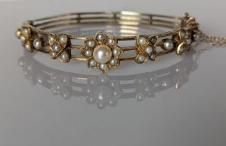 An Edwardian-style yellow gold hinge bangle with pearl decoration and etched design, 60mm, 21.5g