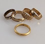 A 22ct yellow gold wedding band, 3mm, size O, 7g; a tri-gold band and three others