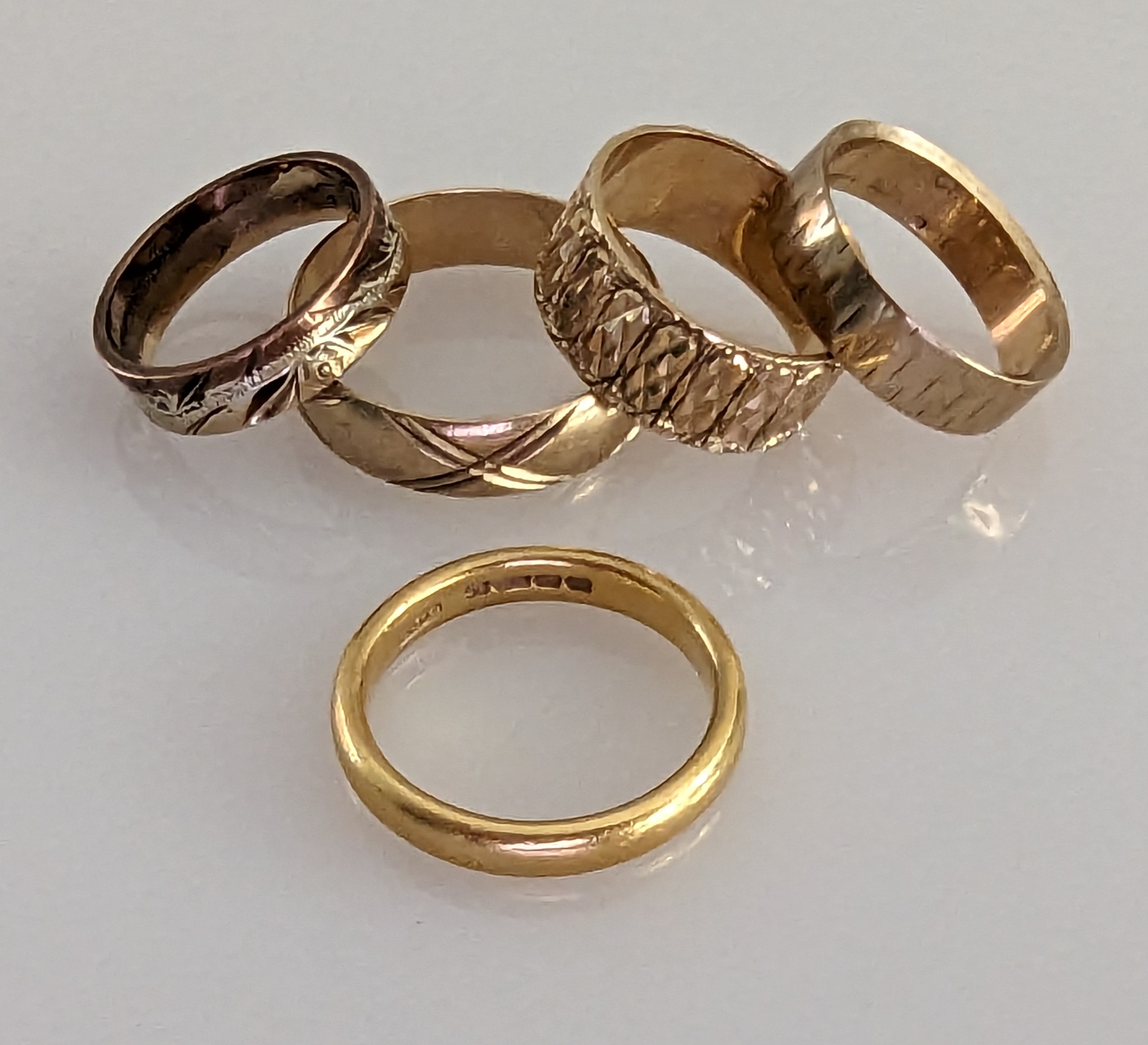 A 22ct yellow gold wedding band, 3mm, size O, 7g; a tri-gold band and three others - Image 2 of 2