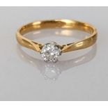 A diamond solitaire ring on an 18ct yellow gold claw setting