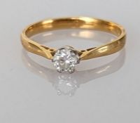 A diamond solitaire ring on an 18ct yellow gold claw setting