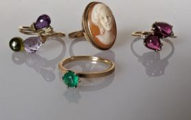 An emerald solitaire on a 14k gold setting, size L, 1.85g; a cameo ring and two gem-set rings