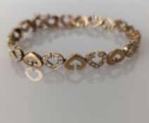 A mid-century gold bracelet with heart-shape links with diamond decoration, 17 cm, hallmarked
