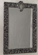 An Edwardian silver-framed table mirror with profuse pierced rococo decoration