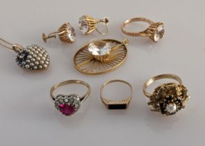 An assortment of gold jewellery to include a pendant/ring/earrings set with faux diamonds