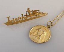 An oriental style gold 'Lucky' brooch and a Madonna disc pendant chain, all 750, 6.6g