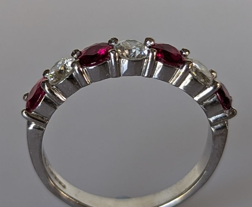 An 18ct white gold ruby and diamond seven-stone half-hoop eternity ring in a claw setting - Image 4 of 5