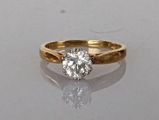 A diamond solitaire ring in an 18ct yellow gold claw setting, the round brilliant-cut diamond 0.50