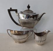An Edwardian silver three-piece tea service with fluted decoration by Roberts & Belk, Sheffield