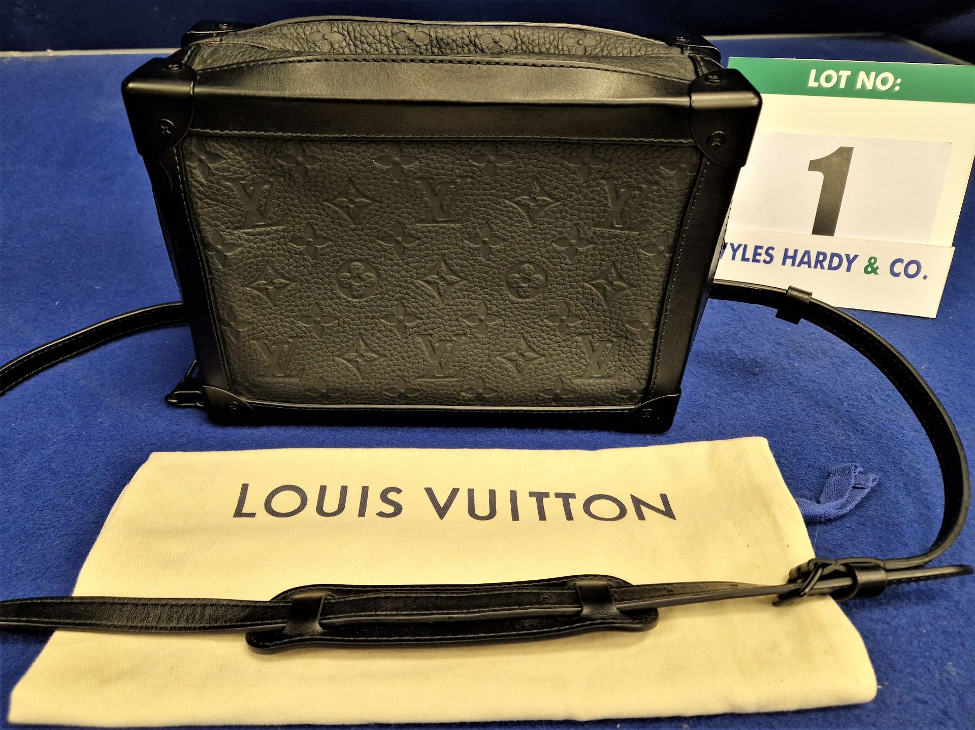 A LOUIS VUITTON Black Taurillon Cowhide Leather Soft Trunk Bag with Monogram Embossed Leather,