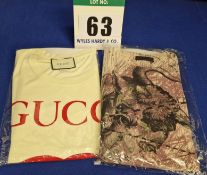 A Set of Two Men's T-Shirts:- - A GUCCI Cotton Cream Round Neck with printed Red GUCCI Double G