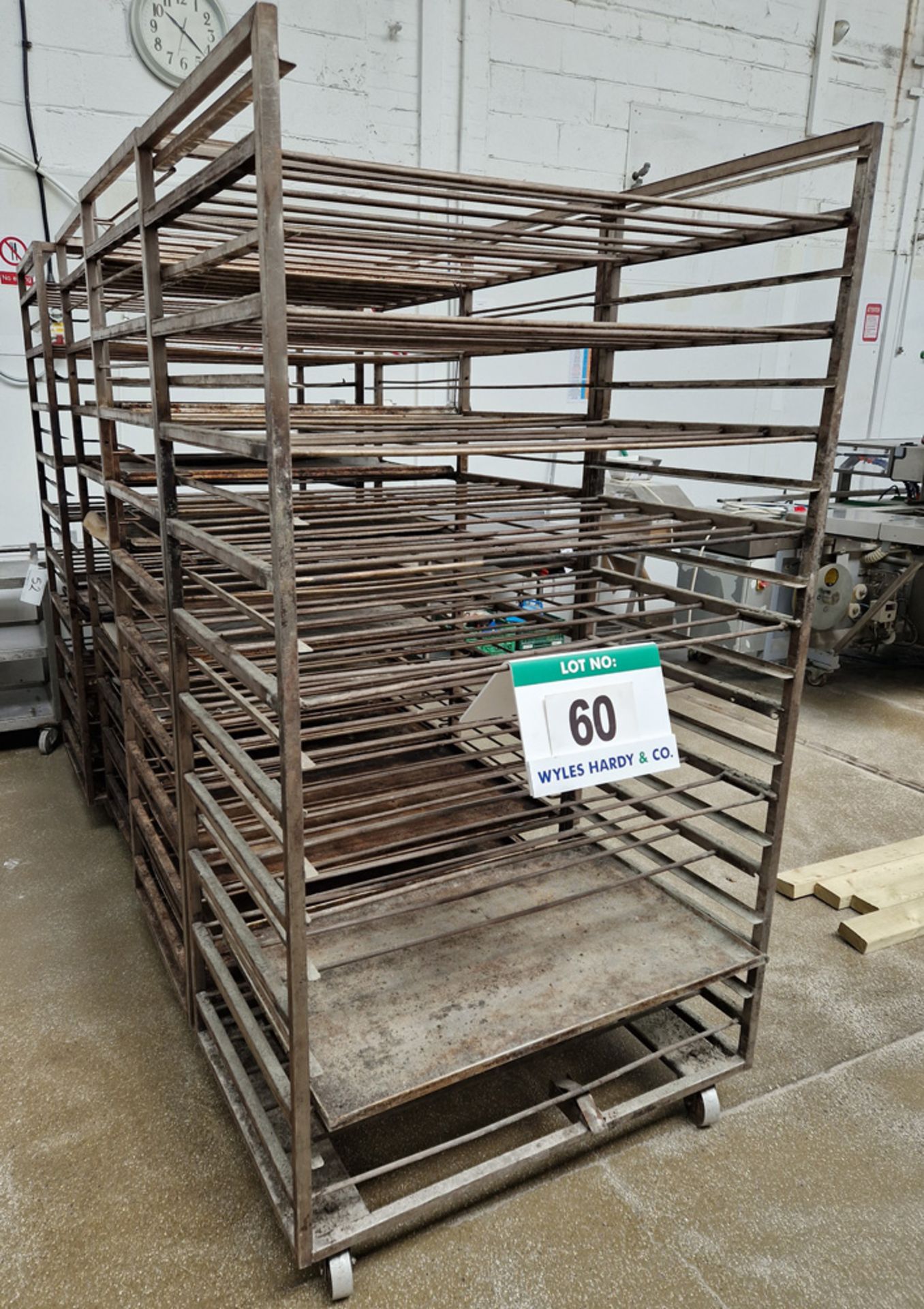 Eight Fabricated Stainless Steel 20-Tray capacity Trolleys, approx. 990mm x 630mm x 1950mm tall