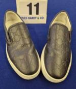 A Pair of GUCCI GG Embossed Leather Slip on Trainers in Black with Double G Monogram and White