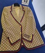 A GUCCI Gold Blazer with Navy Blue Double G Monogram all over and Navy Blue and Red Stripe Trim to