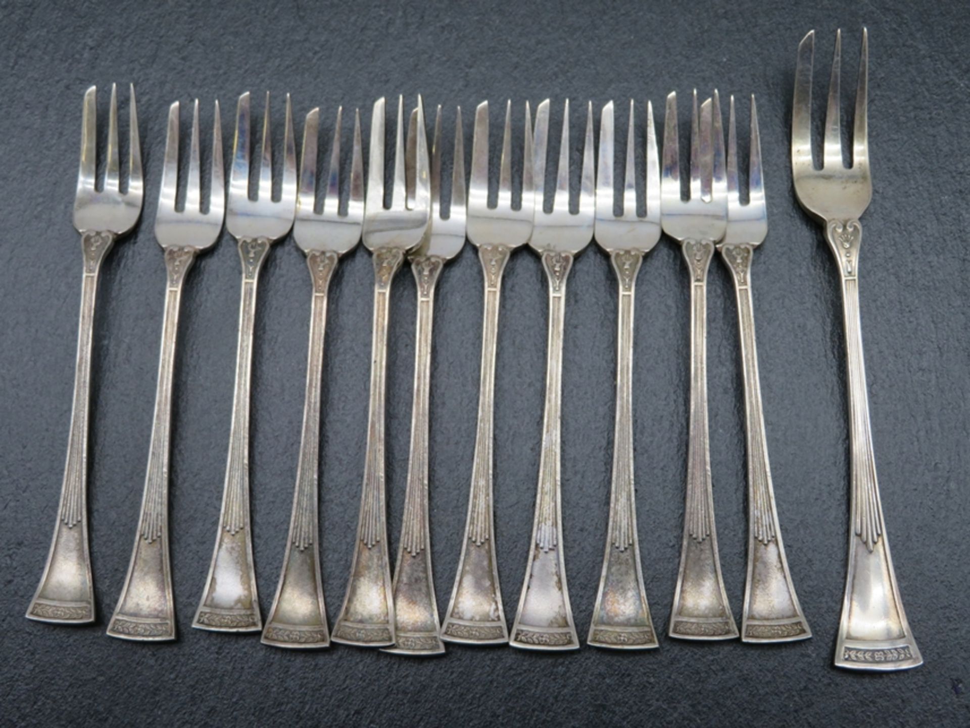 12 Gebäckgabeln, um 1900, Silber 835/000, gepunzt, 112,9 g, l 10,5 cm (1x l 12 cm).