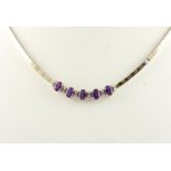 AMETHYST-COLLIER, 585/ooo Weißgold/Gelbgold, besetzt mit fünf Amethysten und zwölf kleinen Brillant