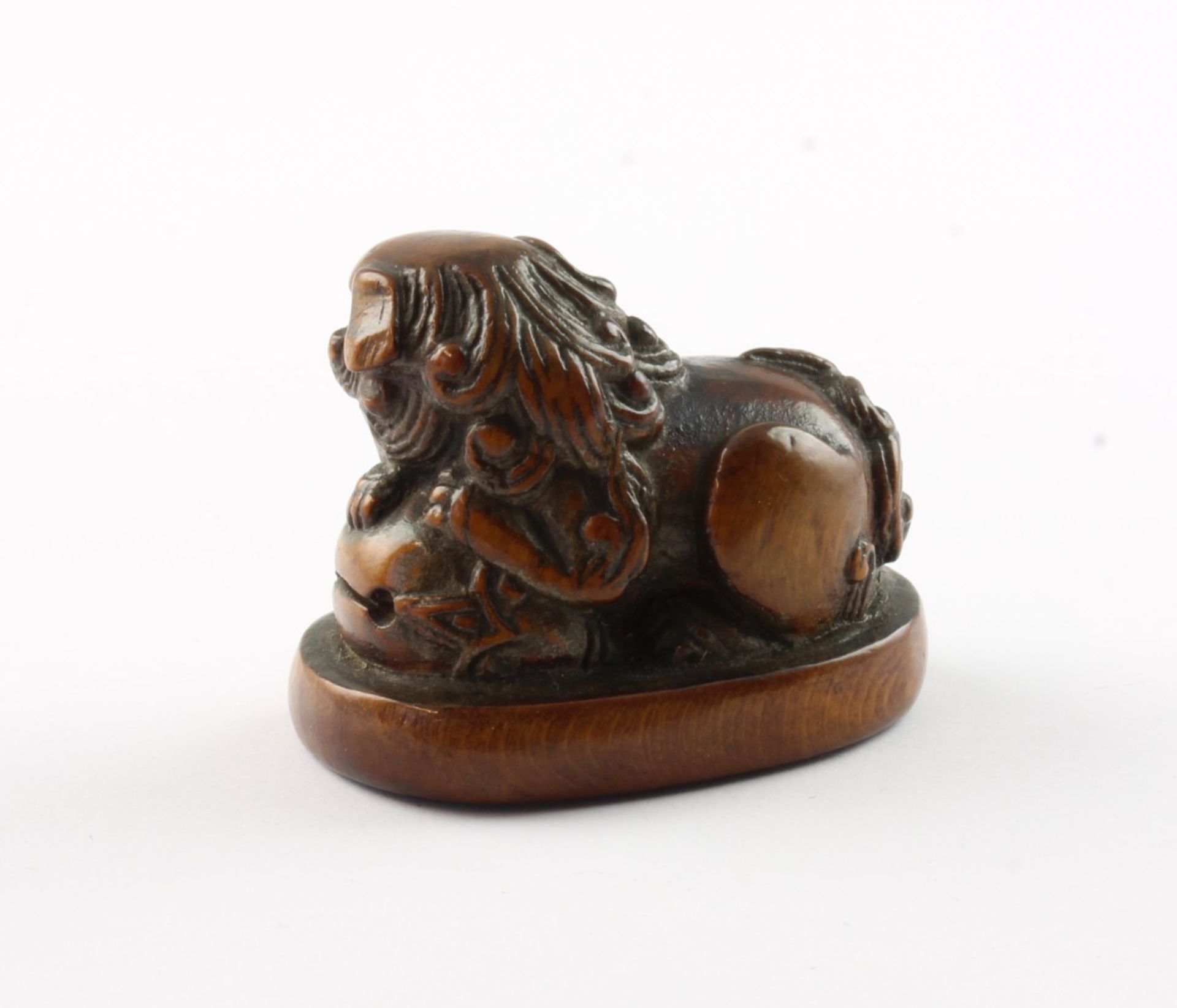 NETSUKE SHISHI MIT MOKUGYO, Buchsbaum, Augen schwarzes Horn, auf einem ovalen Sockel liegt der groß - Image 2 of 3