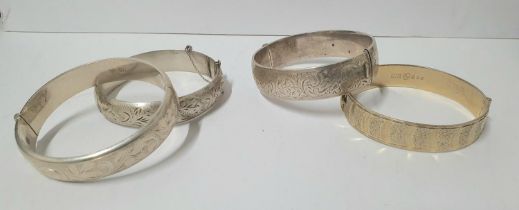 Four English hallmarked engraved silver bracelets, one with 22ct gold plating (4), Approx 100 grams