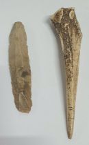 Stone age bone dagger with small remnants of line decoration together with a small Stone age stone