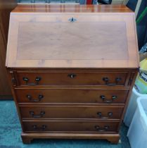 Mid-century bureau with drop-front revealing inner compartments and inlaid top above four drawers,