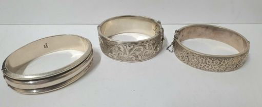 Three heavy hallmarked silver bangles, the 2 engraved bangles both with Birmingham hallmarks, the