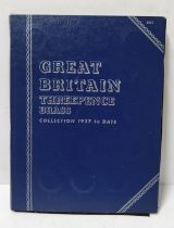 Blue coin album containing GB threepences (1937 - 1967)