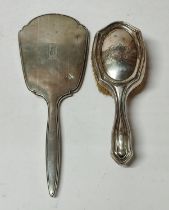 A Silver vanity set comprising of a hand held mirror and brush (2) 465 grams gross