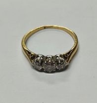 An 18ct. yellow and white gold ring set with a trio of round cut Diamonds approx. 0.35ct. 2 grams