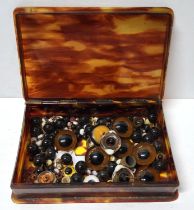 Small antique tortoise shell box containing a quantity of antique glass eyes