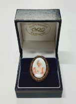 A 9ct. rose gold ring with an oval ceramic female portrait insert 5.14 grams gross