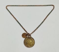 A two-tone chain marked 9ct to the clasp with two coins attached 10.6 grams gross