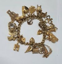 9ct yellow charm bracelet with 20+ charms, 50 grams