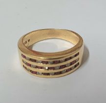 585 stamped gold ring with round cut rubies and round cut diamonds set in 3 rows with 11 stones