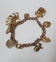 9ct rose gold charm bracelet with 8 charms, 20.4 grams