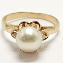 18ct marked gold pearl set ring with diamond set shoulders - size N & 3.8g total weight