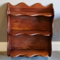 Mahogany wall mounted bookcase measuring W64cm x D25cm x H88cm. In good used condition.