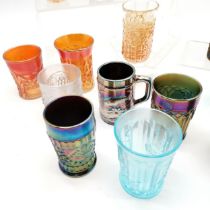 Collection of assorted Carnival glass beakers of varying colours, largest being 11 cm high inscribed