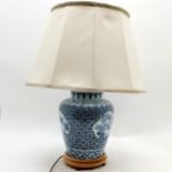 An Oriental decorated lamp on wooden base, complete with shade, lamp base 50cm high, in good used