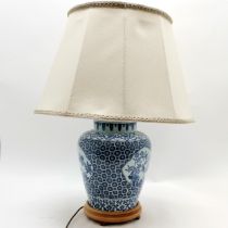 An Oriental decorated lamp on wooden base, complete with shade, lamp base 50cm high, in good used