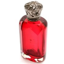 Antique cranberry glass scent bottle with unmarked silver embossed lid - 6cm high & no obvious