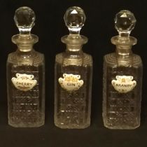 Set of 3 cut glass crystal decanters 28cm high with porcelain Gin, Brandy and Sherry labels - slight