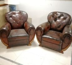 Pair of Art Deco leather club armchairs with button back detail, in worn condition, 90 cm wide, 85