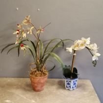 An Artificial orchid in terracotta pot, 60 cm high, t/w another in a oriental decorated pot.