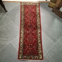 Red ground runner with 3 multicolour Geometric central medallions within fauns border, 70cm x 200cm,