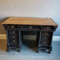 Antique ebonised pedestal leather top writing desk with carved and brass fretwork decoration, turned