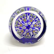Millefiori paperweight with central cane, concentric ring & 7 radial twists separating cane groups