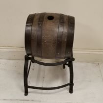 Antique oak and iron bound barrel with cast iron stand, 46cm wide x 73cm high, in used condition.