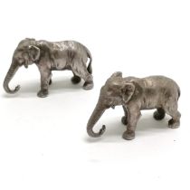 2 x cast metal elephants - largest 3cm high x 5cm long & both have slight deterioration to tails